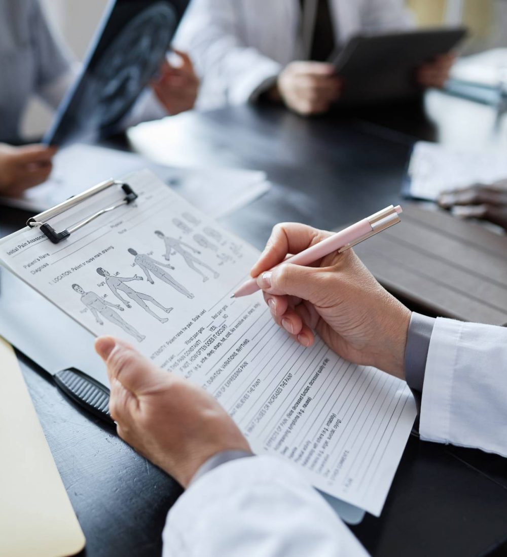 hand-of-clinician-with-pen-filling-in-medical-form-2026-01-08-08-23-43-utc (1)